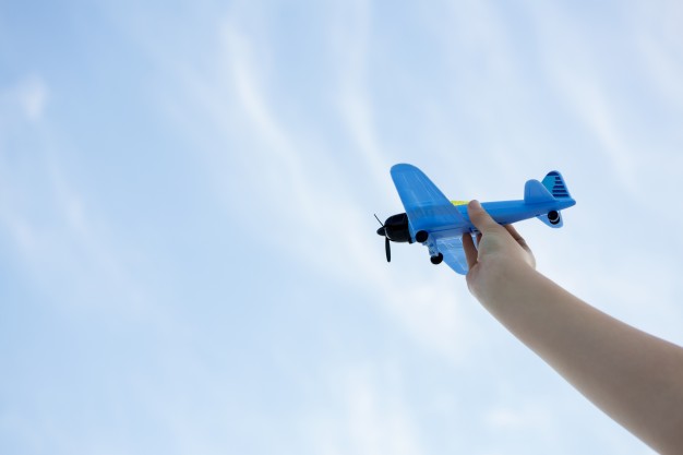 hand-playing-with-toy-plane_1252-549